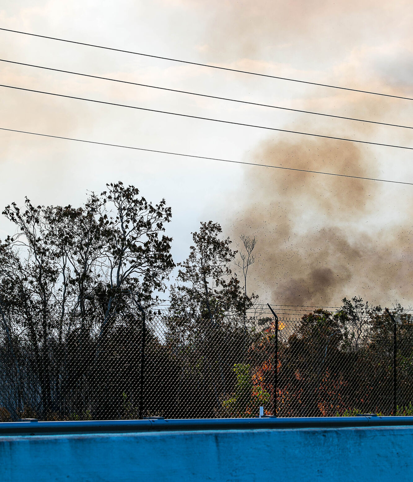 On Wednesday afternoon fire burns along the fence just west of US-5 just south of where the fire started.